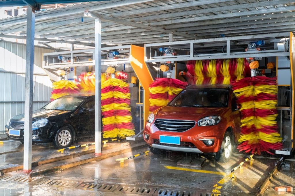 Vehicles going through touchless car wash